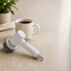 Compact cordless spin scrubber next to a coffee mug for scale